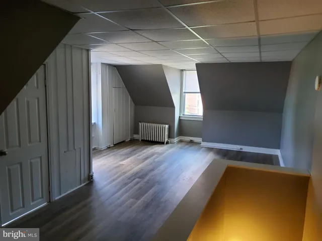 a view of a room with wooden floor