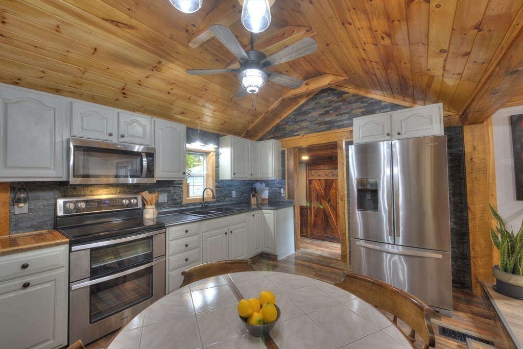 95 Sylvester Road Northampton, MA 01062 - Photo 11 of 42 a kitchen with stainless steel appliances granite countertop a refrigerator a stove and a sink