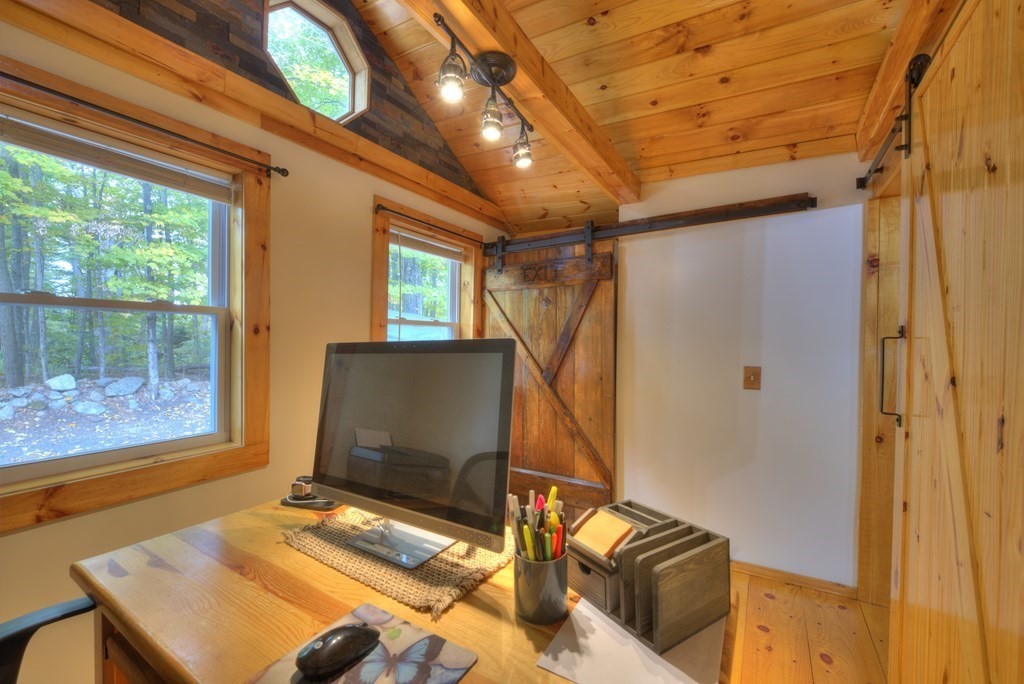 95 Sylvester Road Northampton, MA 01062 - Photo 23 of 42 a bedroom with a bed and a flat tv screen next to a window