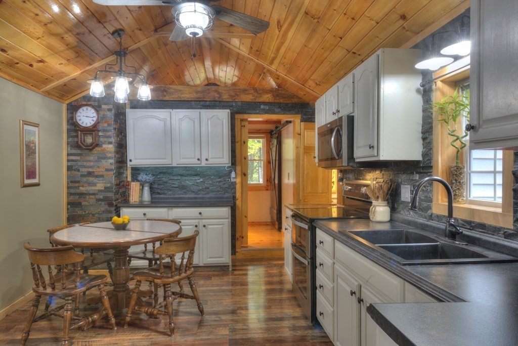 95 Sylvester Road Northampton, MA 01062 - Photo 10 of 42 a kitchen with stainless steel appliances wooden cabinets granite counter tops and a stove
