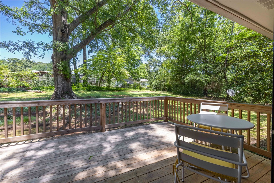 207 Brook Street Clemson, SC 29631 - Photo 2 of 39 A spacious wooden deck extends to a verdant yard, offering a tranquil outdoor retreat.