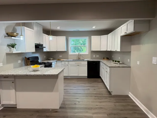 a kitchen with a sink a stove a refrigerator and cabinets