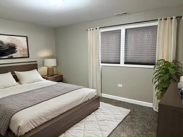 a bedroom with a bed and a window