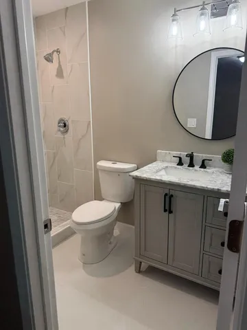 a bathroom with a sink toilet and shower