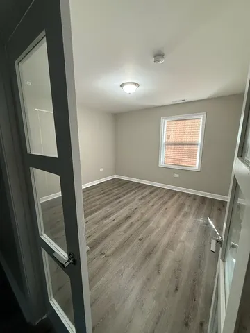 wooden floor in an empty room with a mirror