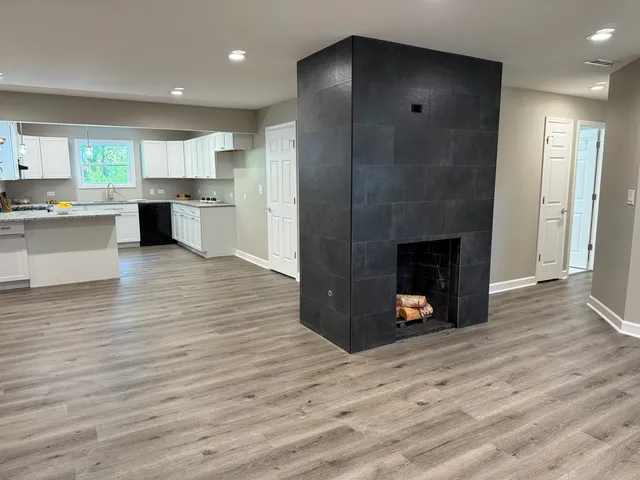 a view of a kitchen with a sink and a fireplace