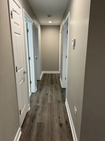 a view of hallway with wooden floor