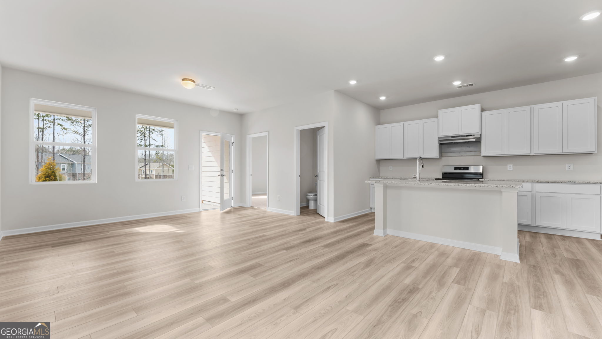 46 Umber Lane Newnan, GA 30263 - Photo 3 of 10 a view of an empty room with window and wooden floor