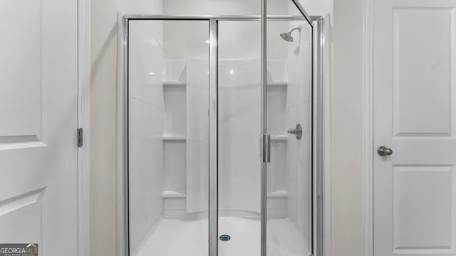 a bathroom with a glass shower door