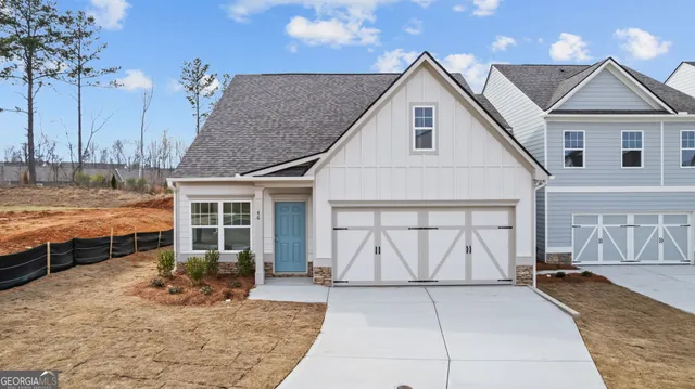 a view of a white house with swimming pool in front of it