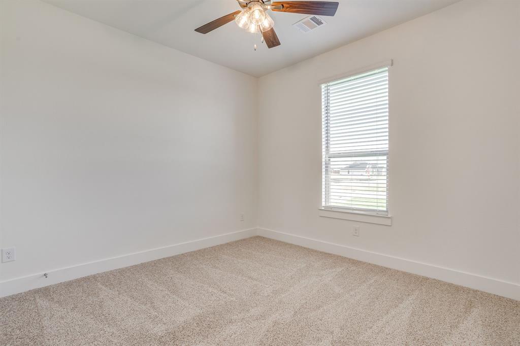 10611 Rye Bread Lane Venus, TX 76084 - Photo 28 of 36 Neutral tone wall finishes, window with horizontal blinds, ceiling fan with light fixture, and carpeted flooring