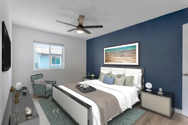a bedroom with a bed couch and window