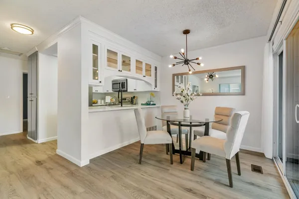 a view of a dining room with furniture and wooden floor