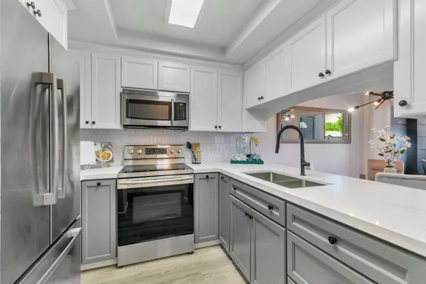 a kitchen with a sink stove and microwave