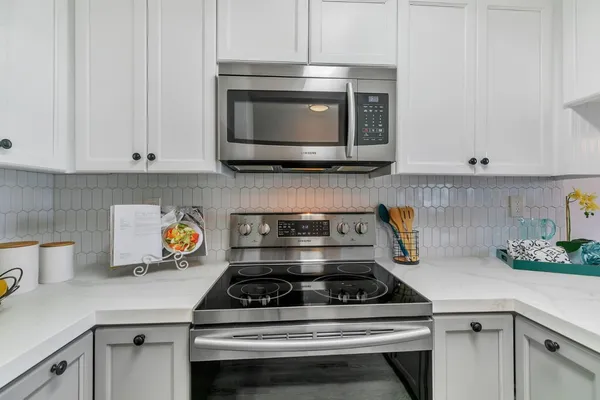 a kitchen with a stove and a microwave