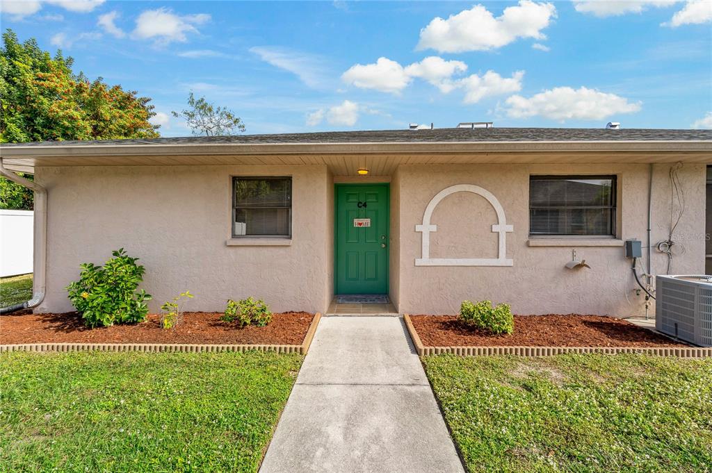 24540 Harbor View Road, Unit C4 Port Charlotte, FL 33980 - Photo 1 of 1 a front view of a house with a yard