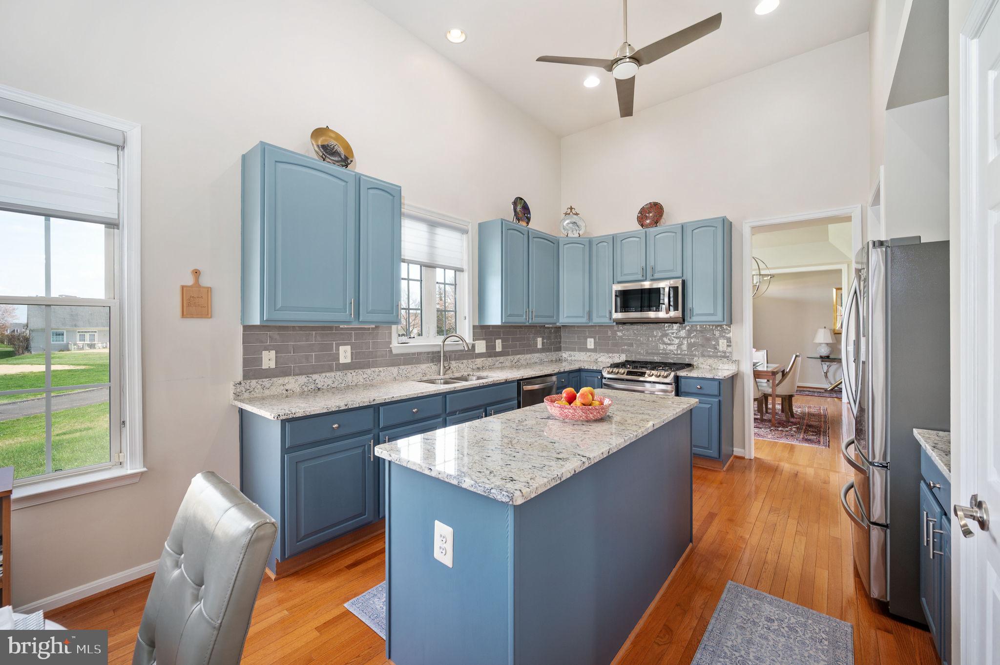 13700 Fieldstone Way Gainesville, VA 20155 - Photo 11 of 53 a kitchen with a stove a refrigerator a sink and dishwasher with wooden floor