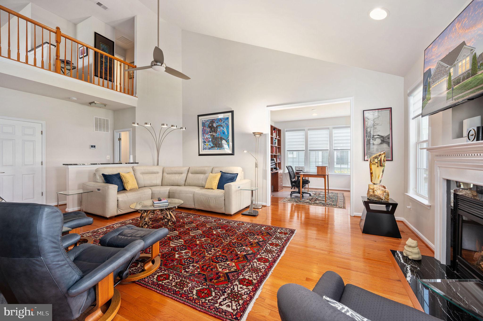 13700 Fieldstone Way Gainesville, VA 20155 - Photo 14 of 53 a living room with furniture hard wood floor and a fireplace