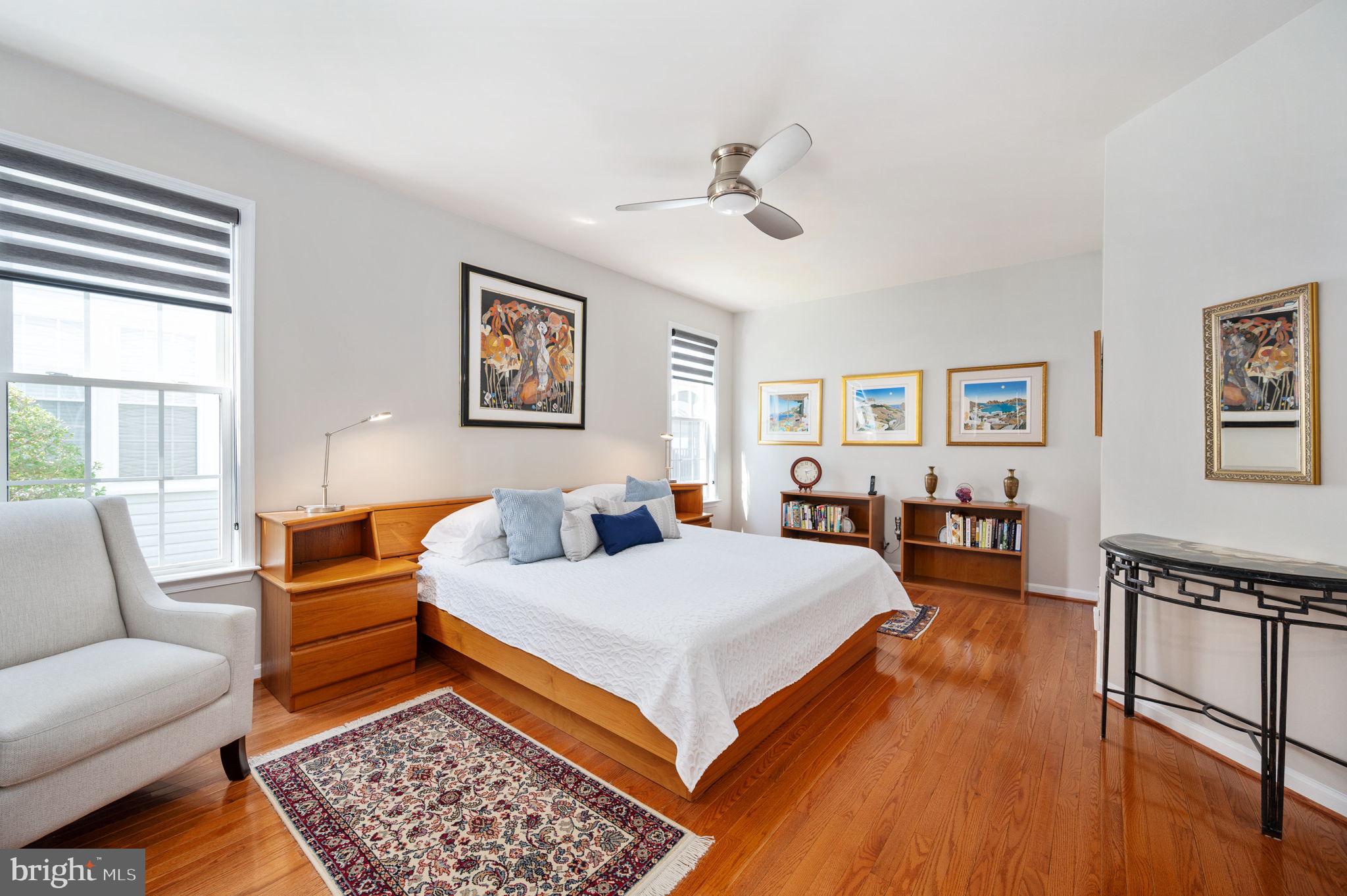 13700 Fieldstone Way Gainesville, VA 20155 - Photo 20 of 53 a bedroom with a large bed a couch and two windows