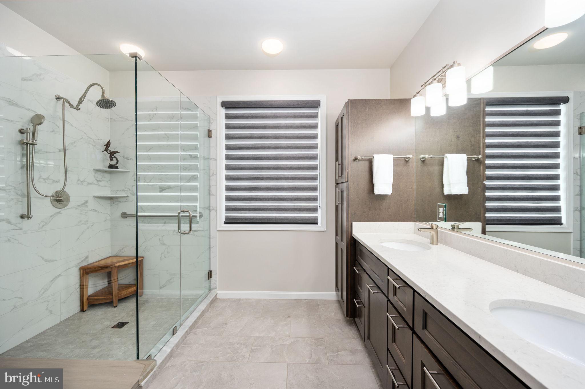13700 Fieldstone Way Gainesville, VA 20155 - Photo 22 of 53 a bathroom with a double vanity sink a mirror and a shower
