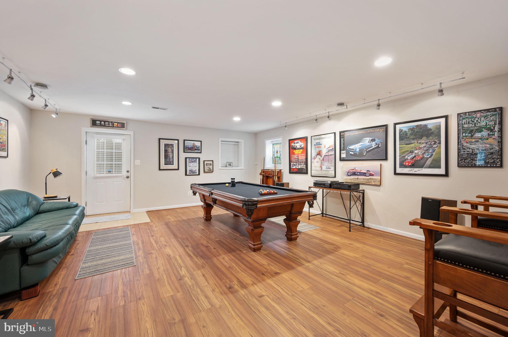 13700 Fieldstone Way Gainesville, VA 20155 - Photo 36 of 53 a living room with furniture a flat screen tv and a wooden floor