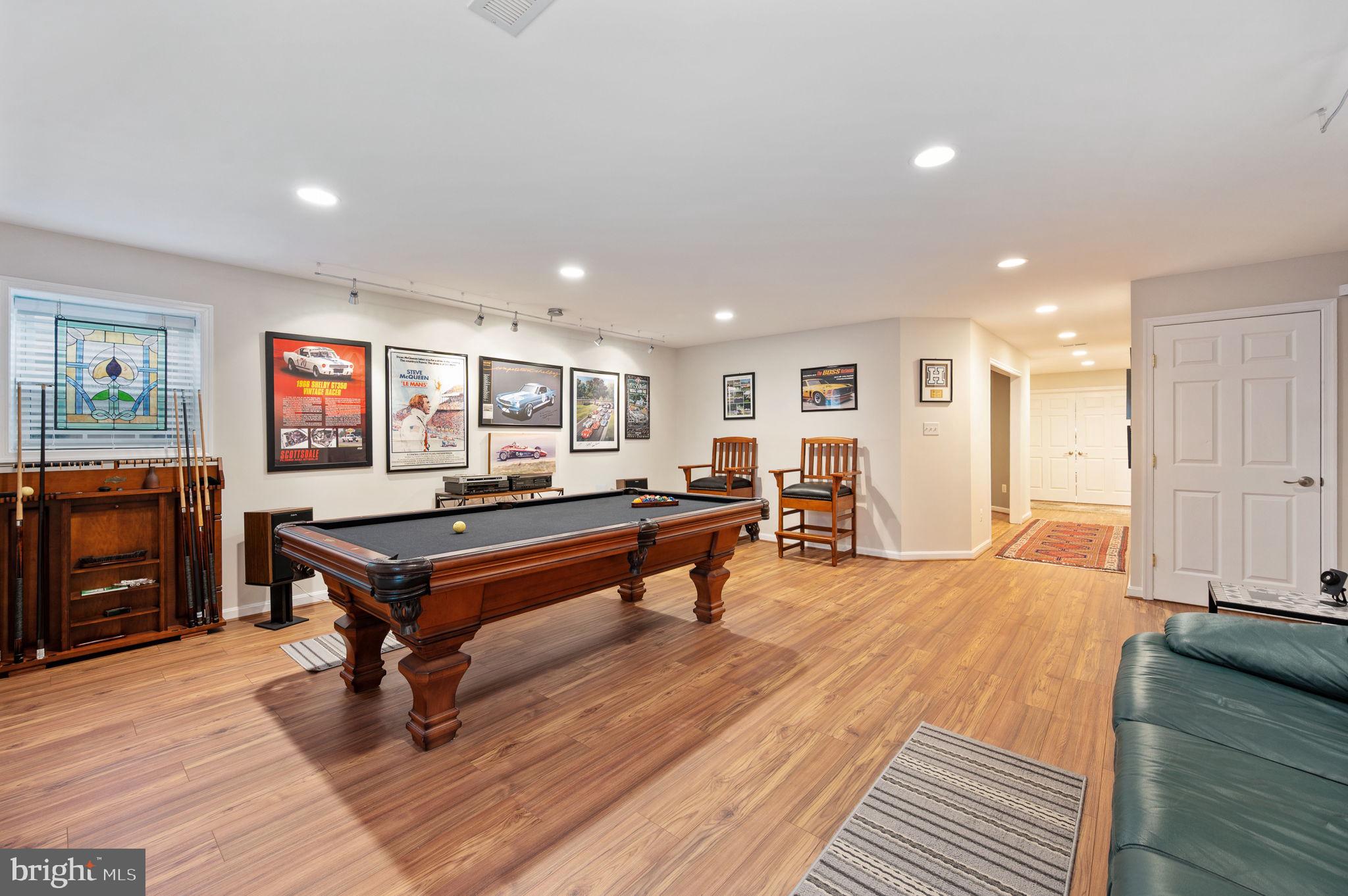13700 Fieldstone Way Gainesville, VA 20155 - Photo 37 of 53 a living room with furniture a flat screen tv and a table