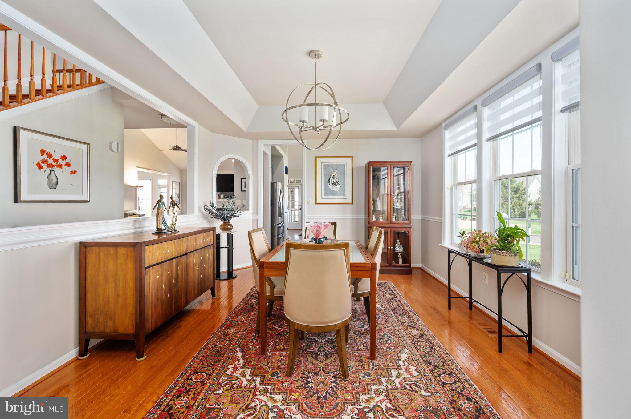 13700 Fieldstone Way Gainesville, VA 20155 - Photo 7 of 53 a large living room with stainless steel appliances granite countertop furniture a fireplace and a large window