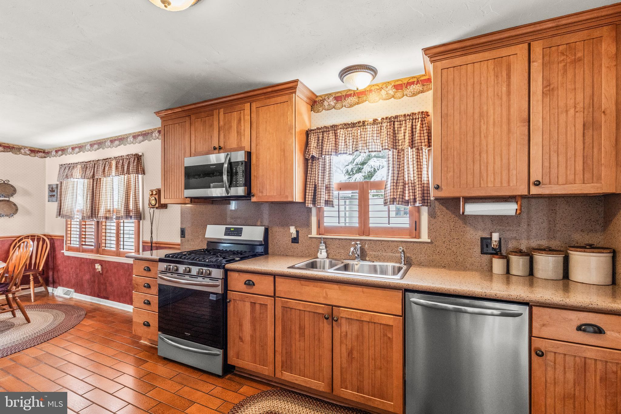 136 Conewago Drive Hanover, PA 17331 - Photo 14 of 41 a kitchen with stainless steel appliances granite countertop a stove a sink dishwasher and a microwave oven with cabinets