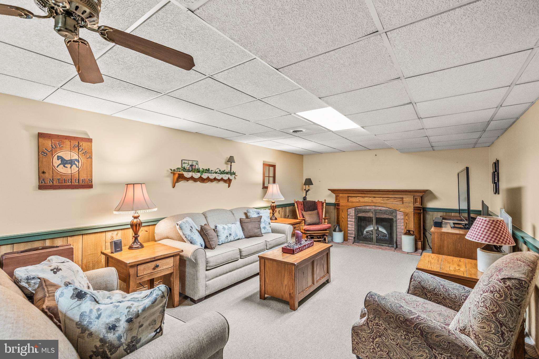 136 Conewago Drive Hanover, PA 17331 - Photo 28 of 41 a living room with furniture a fireplace and a flat screen tv