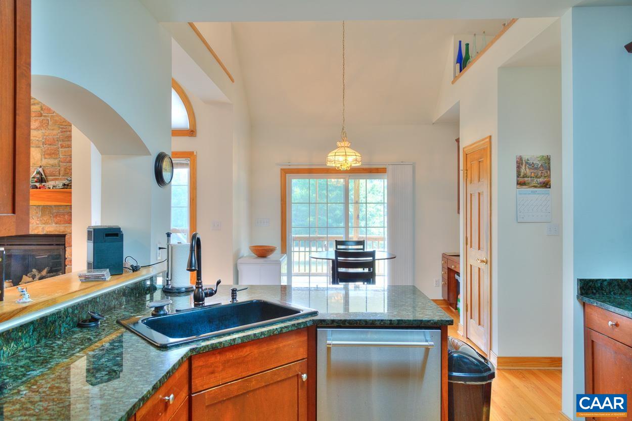 1908 Hollands Road Palmyra, VA 22963 - Photo 17 of 41 a kitchen with granite countertop cabinets a sink and a large window