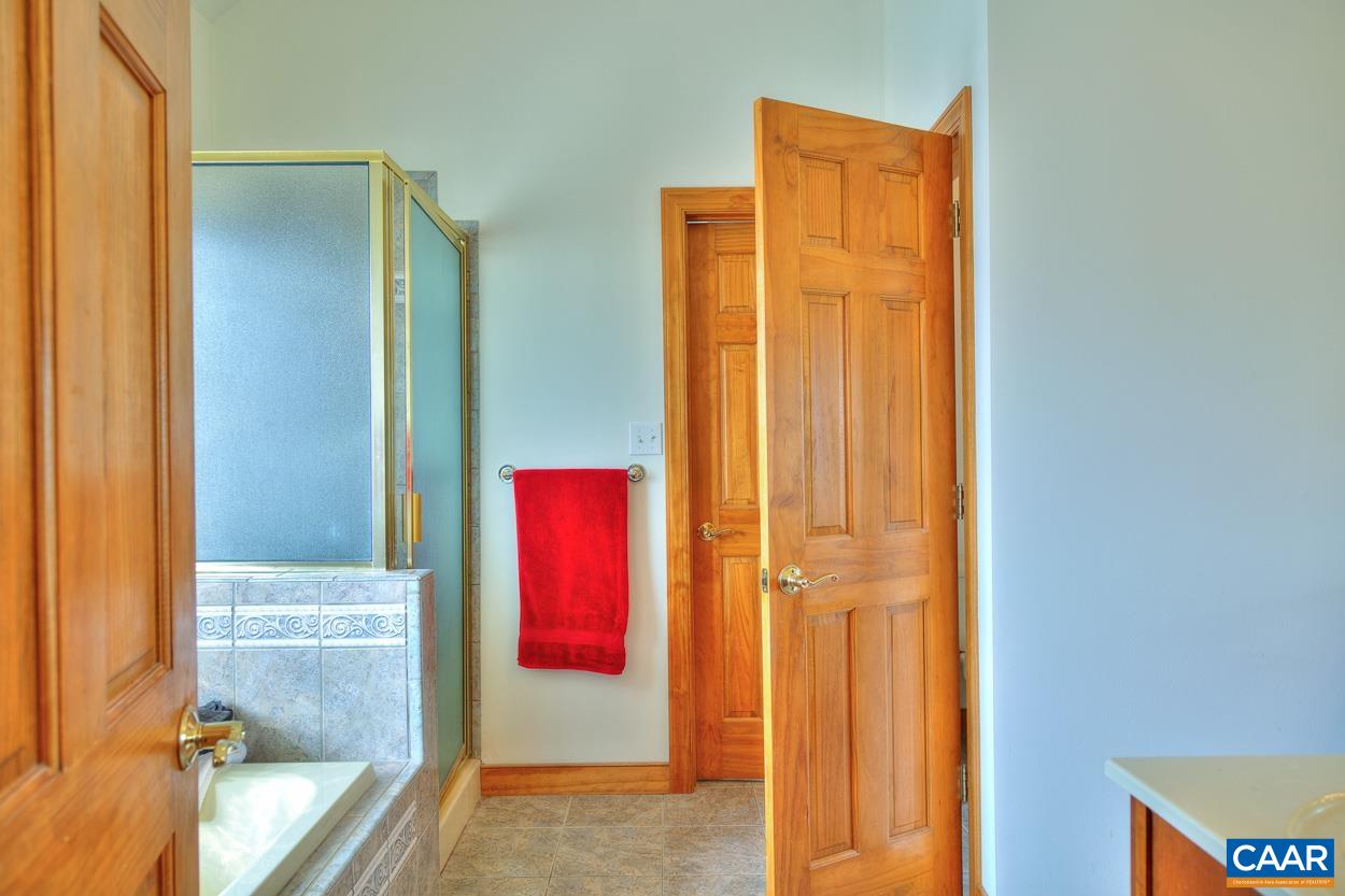 1908 Hollands Road Palmyra, VA 22963 - Photo 24 of 41 a view of a bathroom with a tub and shower