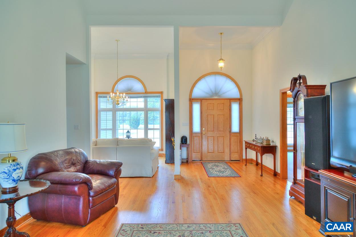1908 Hollands Road Palmyra, VA 22963 - Photo 10 of 41 a living room with furniture a flat screen tv and wooden floor