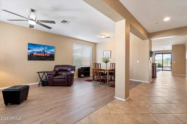 a spacious bedroom with a bed a chandelier and large window