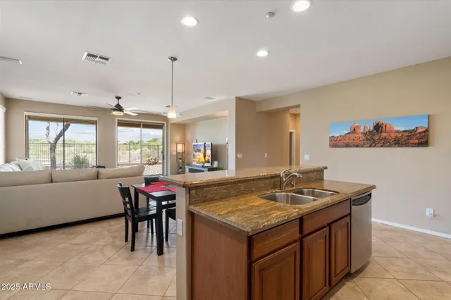 a kitchen with stainless steel appliances granite countertop a refrigerator and a sink