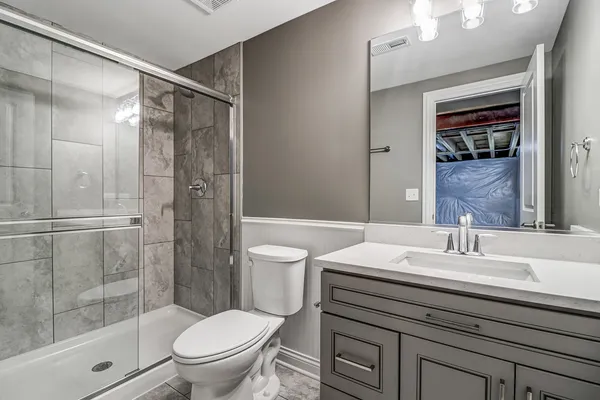 a bathroom with a sink toilet and shower