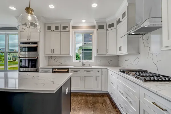a kitchen with stainless steel appliances granite countertop a sink stove and cabinets