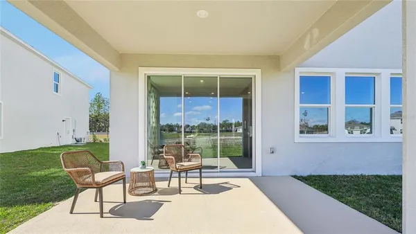 a building outdoor space with patio furniture and a potted plant