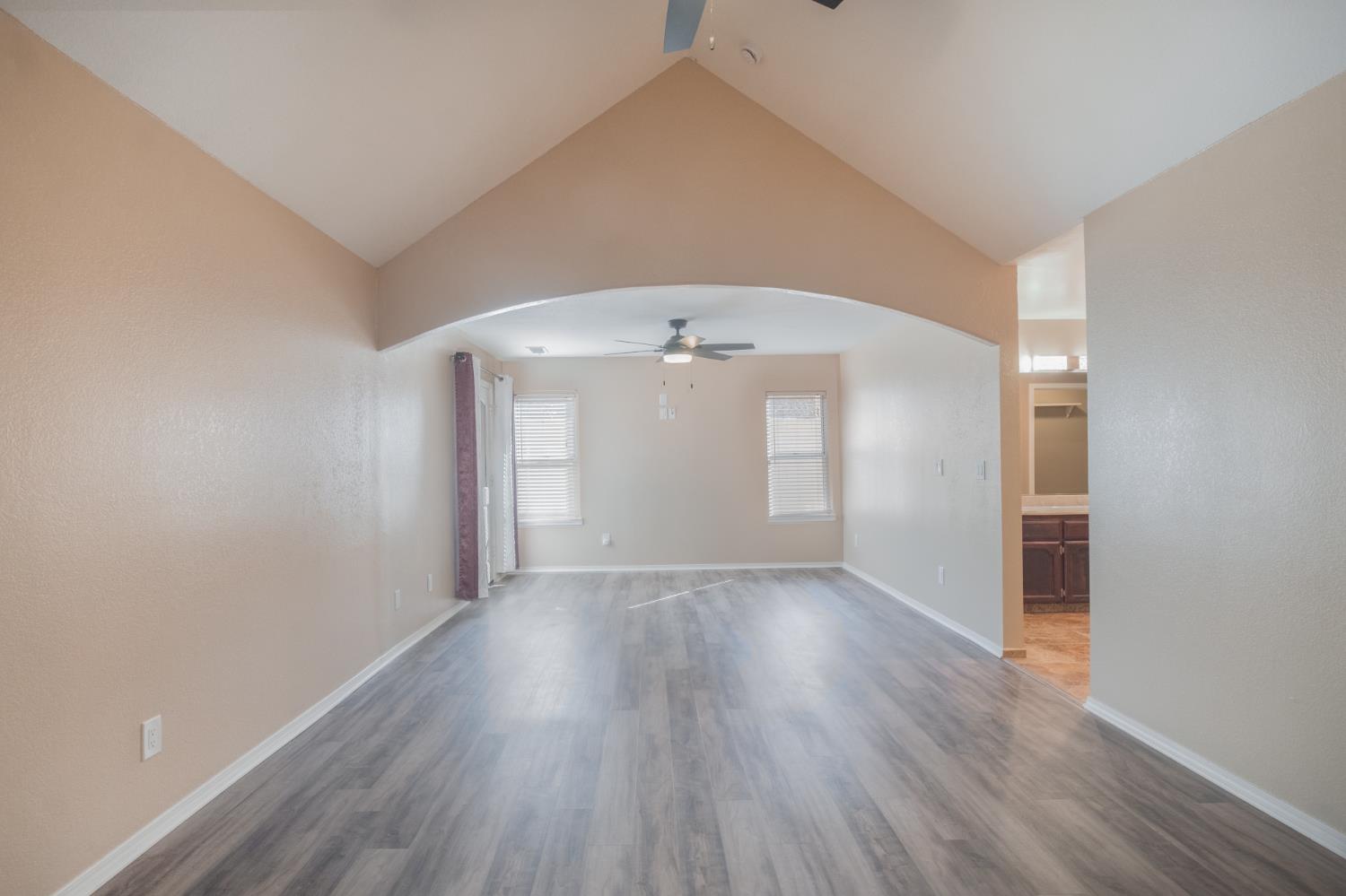 3147 Boulder Avenue Madera, CA 93637 - Photo 11 of 29 an empty room with wooden floor and windows