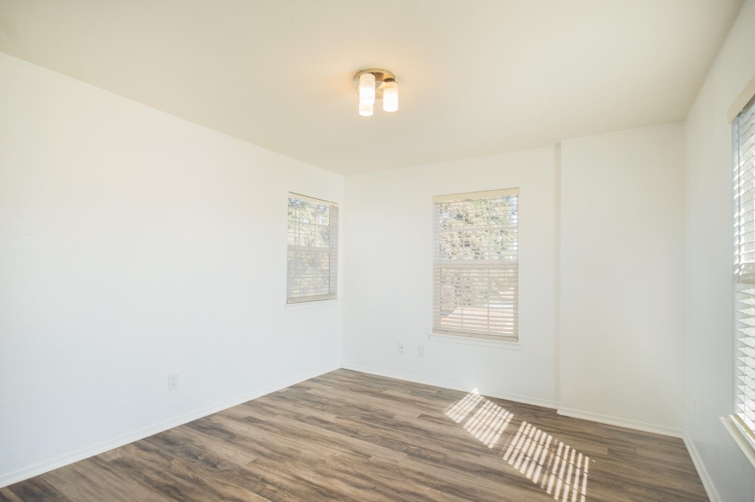 3147 Boulder Avenue Madera, CA 93637 - Photo 18 of 29 a view of a bedroom with wooden floor and window