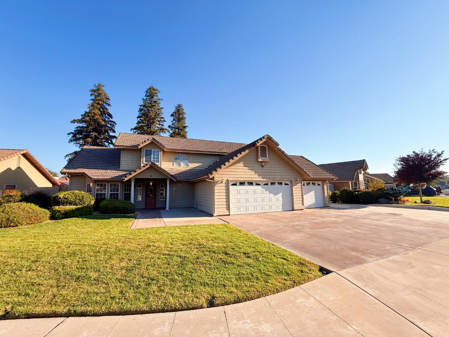 3147 Boulder Avenue Madera, CA 93637 - Photo 2 of 25 a view of a house with a yard and potted plants