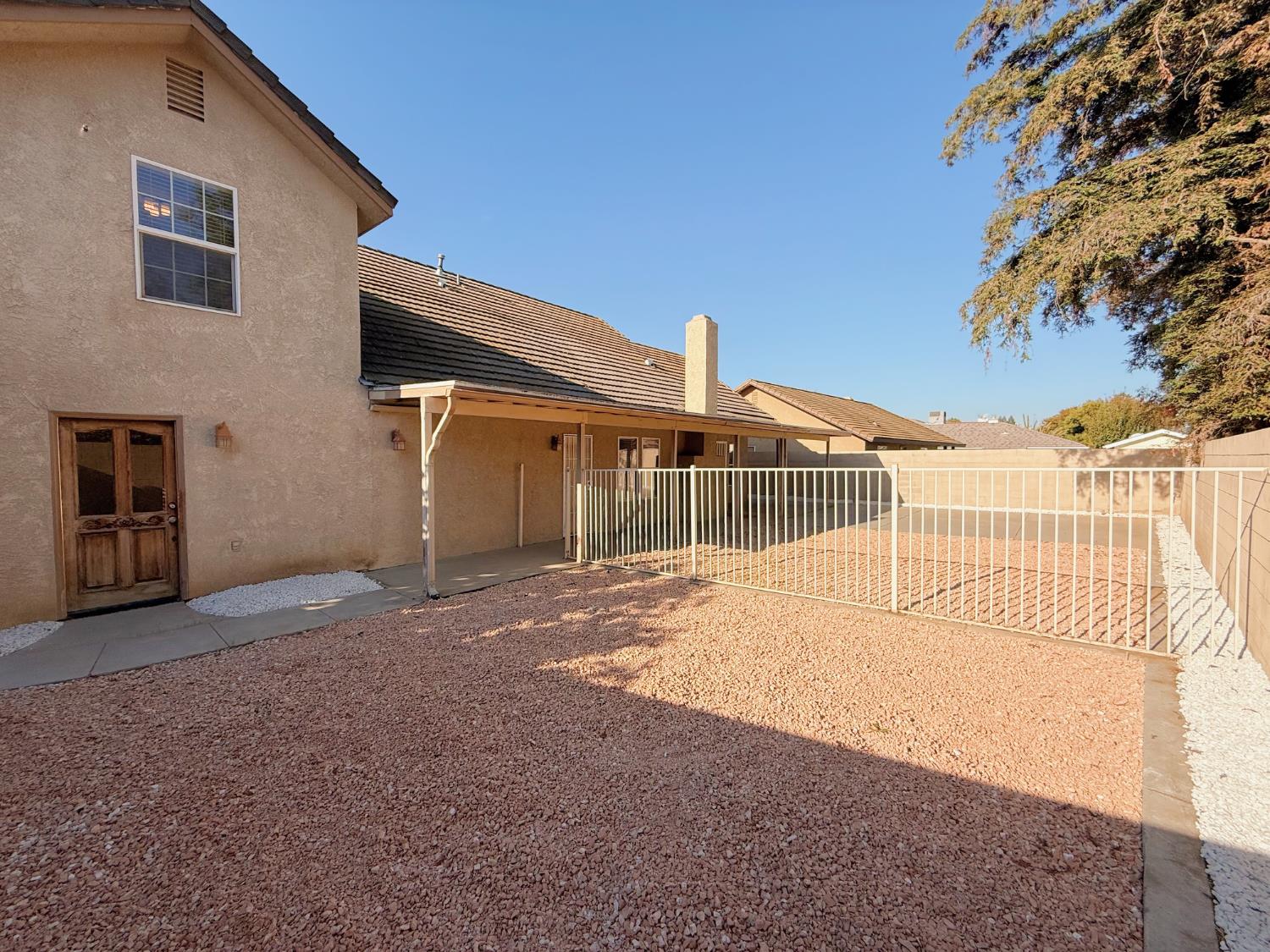 3147 Boulder Avenue Madera, CA 93637 - Photo 21 of 25 a view of a house with a backyard