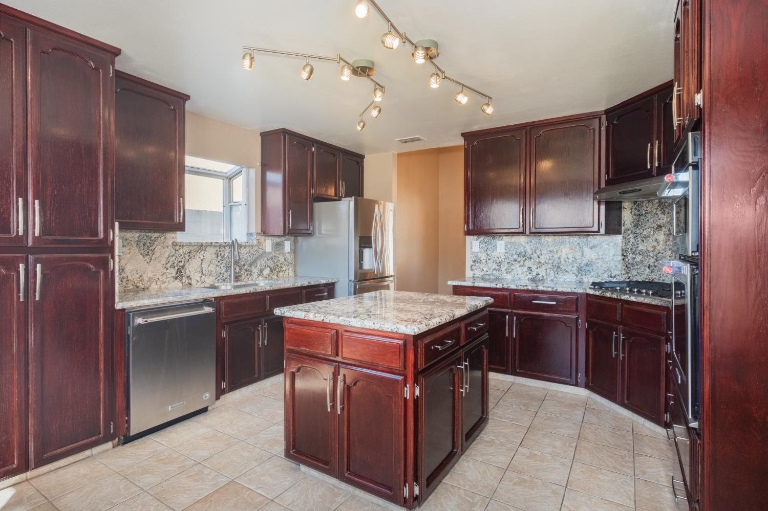 3147 Boulder Avenue Madera, CA 93637 - Photo 10 of 29 a kitchen with a stove top oven sink and cabinets