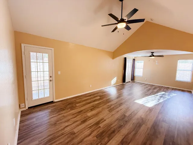 wooden floor in an empty room with a window