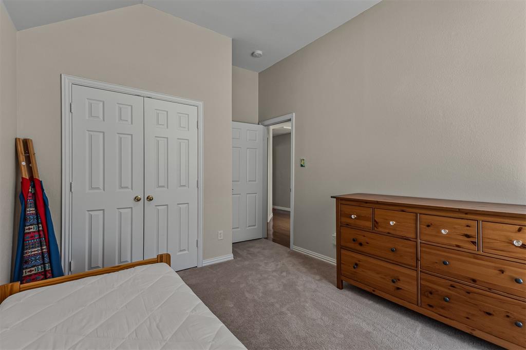 9301 Nottingham Court Rowlett, TX 75088 - Photo 22 of 39 Room featuring vaulted ceilings and carpet flooring