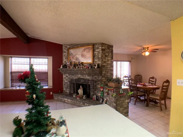 a living room with furniture a fireplace and a potted plant