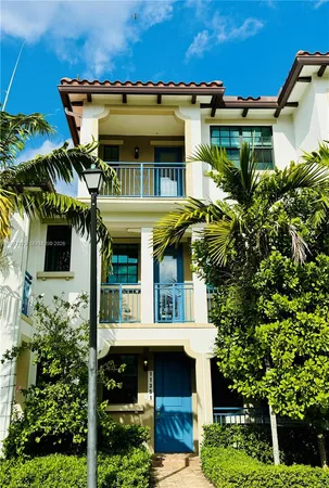 a front view of a house with plants