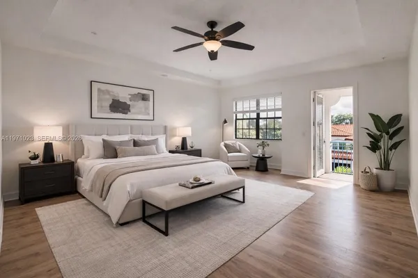 a spacious bedroom with a bed couch and a window
