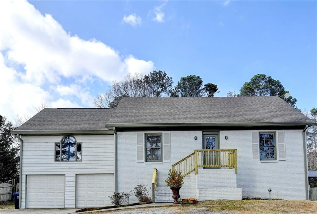 356 Camp Perrin Road Northeast Lawrenceville, GA 30043 - Photo 1 of 1 a front view of a house with garden