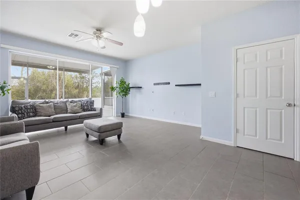 a living room with furniture and large windows
