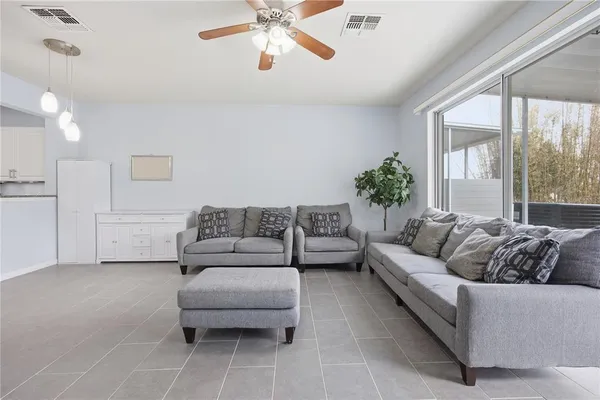 a living room with furniture and a large window